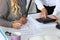 Two female accountants counting on calculator