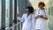 Two female african-american doctors examines x-ray of lungs, holding it in hands indoors. Two specialists holds