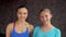 Two female athletes looking at the camera, portrait. close-up sport, fitness, emotion, expression and people concept -