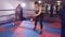 Two female boxers train with balls in the ring. Girls in training