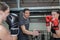 Two female boxers training with male coach