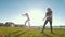 Two female cheerleaders workout outdoors at sunny day