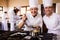 Two female chefs preparing food in kitchen