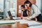 Two female colleagues in office working together.