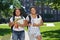 Two female college students on campus with backpacks and books