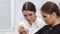 Two female confectioners making macaroons with creamy filling