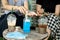 Two female customers cleaning their hand  with alcohol gel at coffee shop, new normal concept