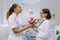 Two female dentists with a bouquet of flowers in the dental office. National Doctor`s day