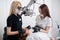 Two female dentists checking up patient teeth with dental tools at dental clinic office