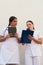 Two female doctors looking at the clipboard while working at the hospital