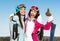 Two female downhill skier friends thumb up