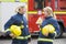 Two female firefighters by a fire engine