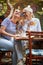 Two female friends of different generations joking while they have a drink in the bar. Leisure, bar, friendship, outdoor