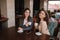 Two female friends drink coffe in restauratn and speak. Beautiful women metting in cafe. End of quarantine