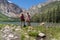 Two female friends enjoy the view at Parker Lake near June Lake California in Eastern Sierra mountains
