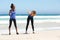 Two female friends enjoying workout at the beach