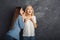 Two female friends having fun at studio background