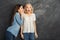 Two female friends having fun at studio background