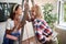 Two female friends laughing and smiling watching at each other in apartment. renovation, apartment, talking, communication, love