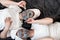 Two female friends lying on the floor together with facial masks and slice cucumbers