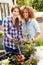 Two Female Friends Planting Rooftop Garden Together