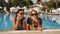 Two female friends, while in the pool at the side and lowering medical masks on their chin, drink colorful alcoholic