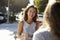 Two female friends talking over coffee outside a cafe