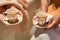 Two female guests hold tiny delicate cups of Masala Chai at a fancy Arabic wedding.