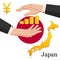 Two female hands around gold yen coins on the background of the map of Japan and the national flag