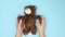 two female hands hold a brown teddy bear on a blue background