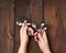 Two female hands holding a set of small metal teaspoons