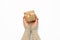 Two female hands holding a square golden gift box with a bow on a white background, concept of gratitude