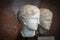 Two female head sculptures eroded by the passage of time