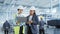 Two Female Heavy Industry Employees in Hard Hats at Factory. Discussing Job Assignments at