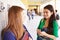 Two Female High School Students Talking By Lockers