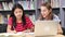 Two female high school students working at laptop