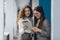 Two female managing directors discussing ideas of project on digital tablet while walking down in office hall, confident women