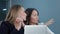 Two female managing directors discussing ideas of project while sitting on conference in office hall