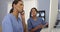 Two female medical personnel working as a team using modern technology