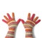 Two female palms in knitted multi-colored mittens on a white background