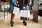 Two female persons with shopping bags in shop