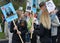 Two female pilot cadets hold portraits of pilot relatives in the Immortal regiment on 9 May, 2016 in Ulyanovsk, Russia