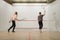 Two female players with rackets, squash game