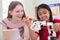 Two Female Pupils In Science Lesson Studying Robotics