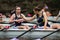 Two female rowers discussing tactics before the start of the race with one athlete pointing