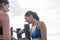 Two female runners talking at the beach