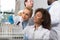 Two Female Scientist Examine Sample Working In Modern Laboratory, Group Of Researchers Making Experiment