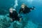 Two female scuba divers dive together