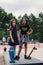 Two female skaters best friends hangout at the skate park on sunset .Laughing and fun. young girls