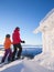 Two female skiers standing next to a frosty cabin